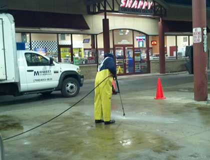 Hot-water steam cleaning at a service station with a Midwest Maintenance truck