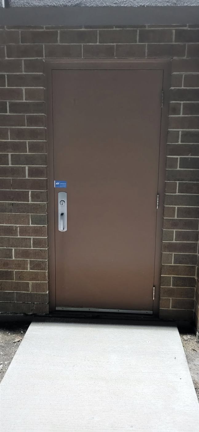 Before: Suite number installed on a service door