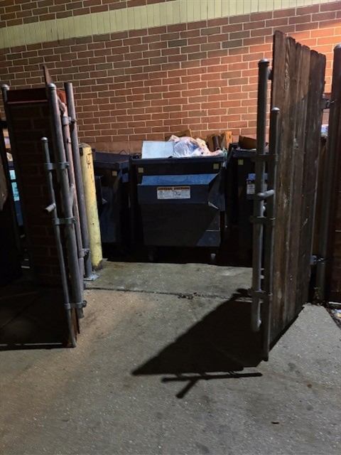 After: Dumpster corral cleaned up and gates secured