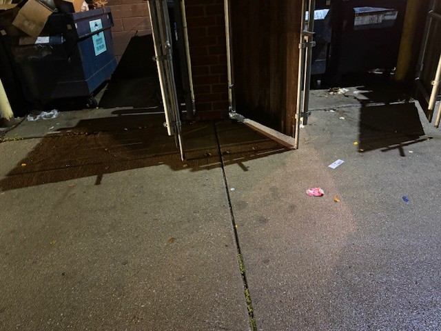 Before: Dumpster corral cleaned up and gates secured
