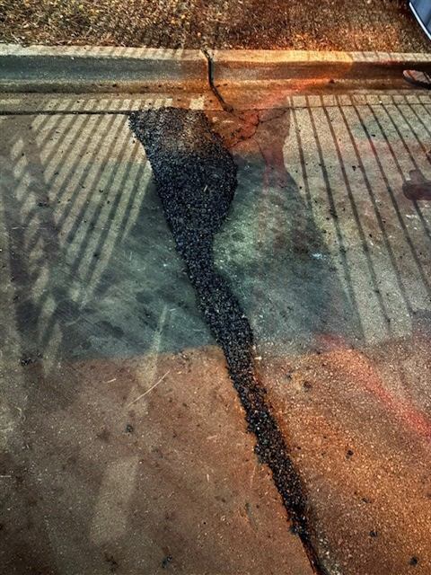 After: Cold patch pothole repair along a curb