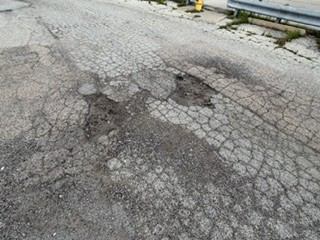 Before: Cold patch repair of multiple potholes