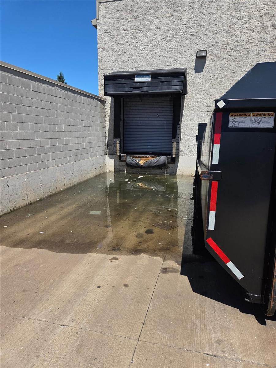 Before: Loading dock drain cleared by our crew