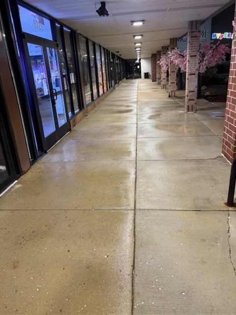 After: Power washing: covered storefront walkway cleaned overnight