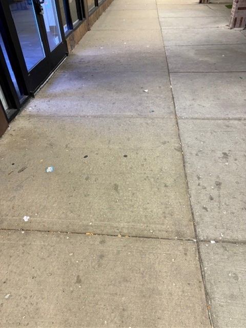 Before: Power washing: covered storefront walkway cleaned overnight