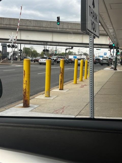 Before: Storefront bollards repainted