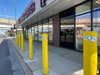 Before: Stickers removed from storefront bollards