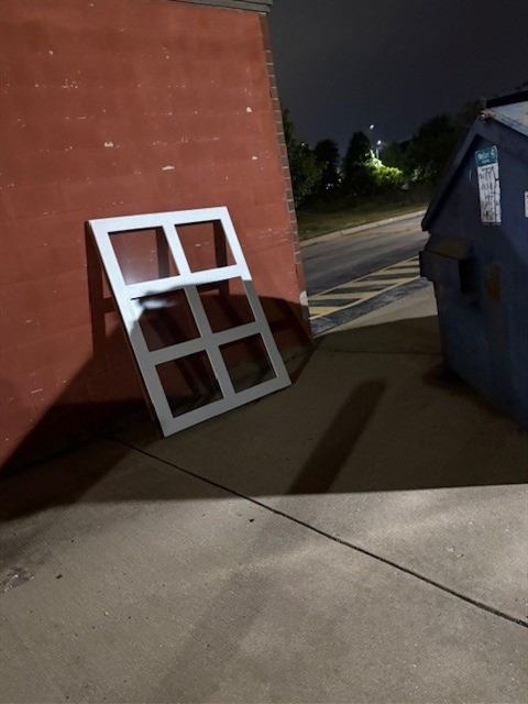 Before: Dumped window frame removed from a shopping center