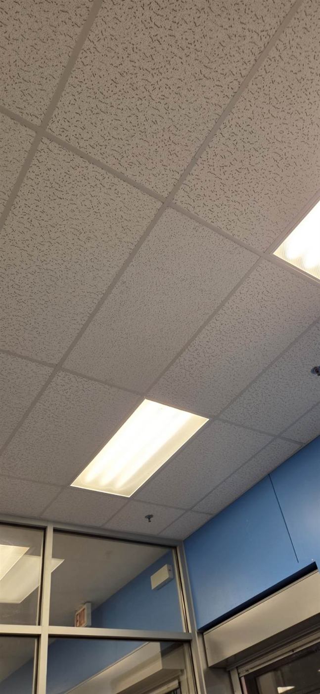 After: Water-damaged ceiling tiles replaced in a tenant space