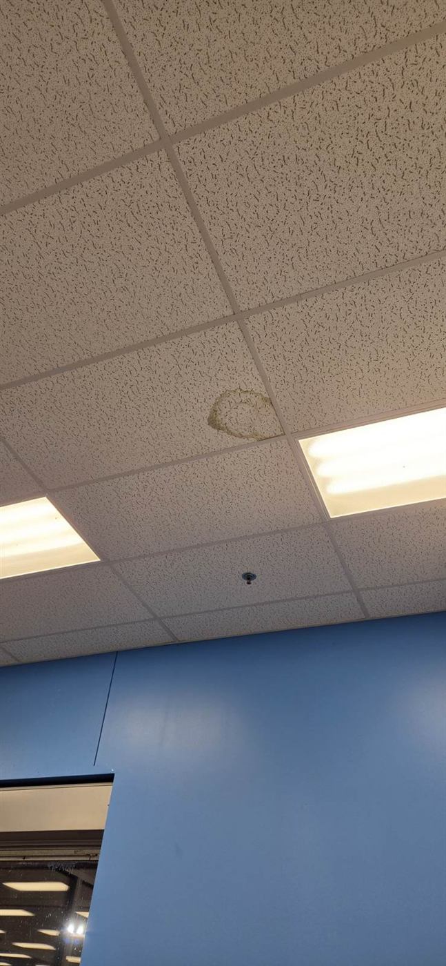 Before: Water-damaged ceiling tiles replaced in a tenant space
