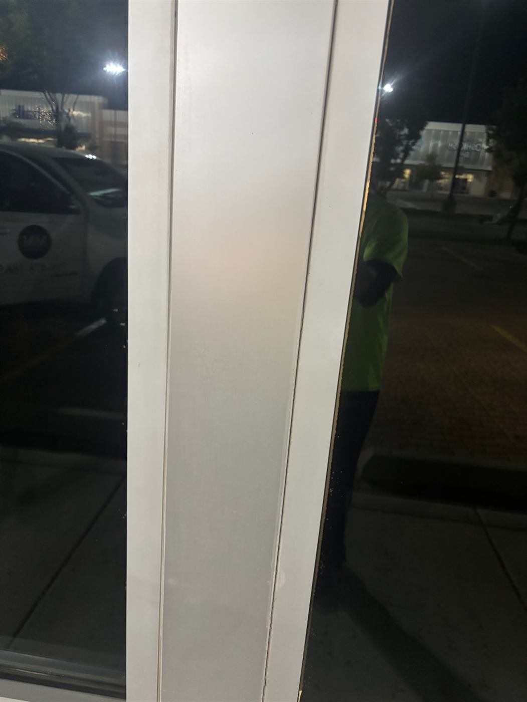 After: Graffiti removed from a storefront door frame