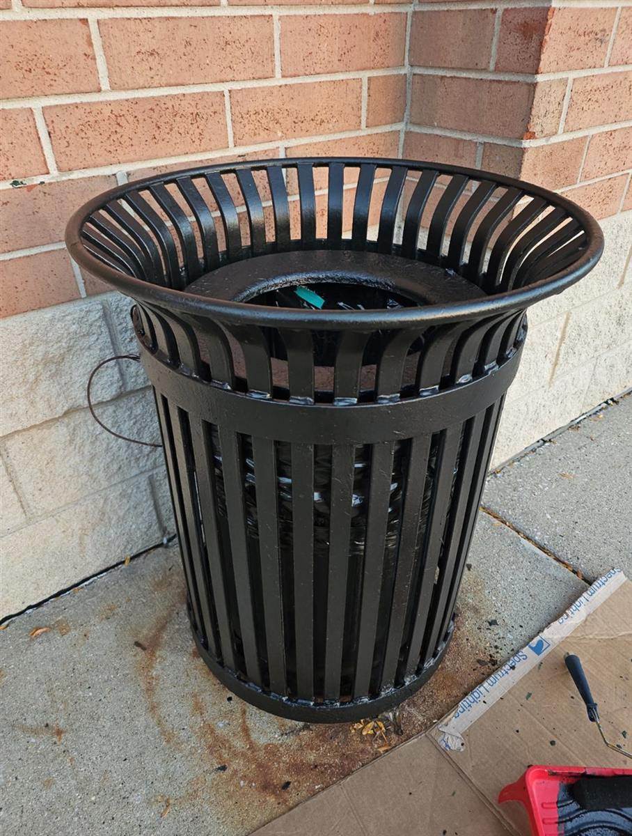 After: Rusted trash receptacle repainted