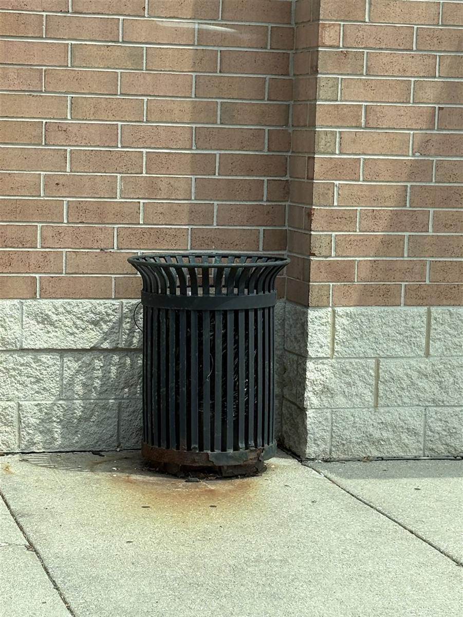Before: Rusted trash receptacle repainted