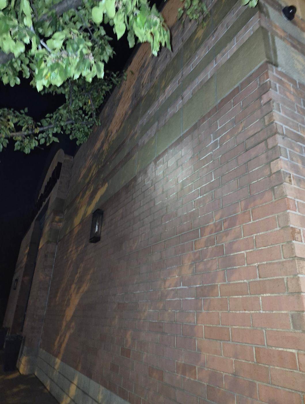 Exterior wall power washing at night