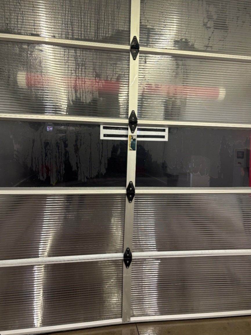 After: Car wash bay door steam cleaned