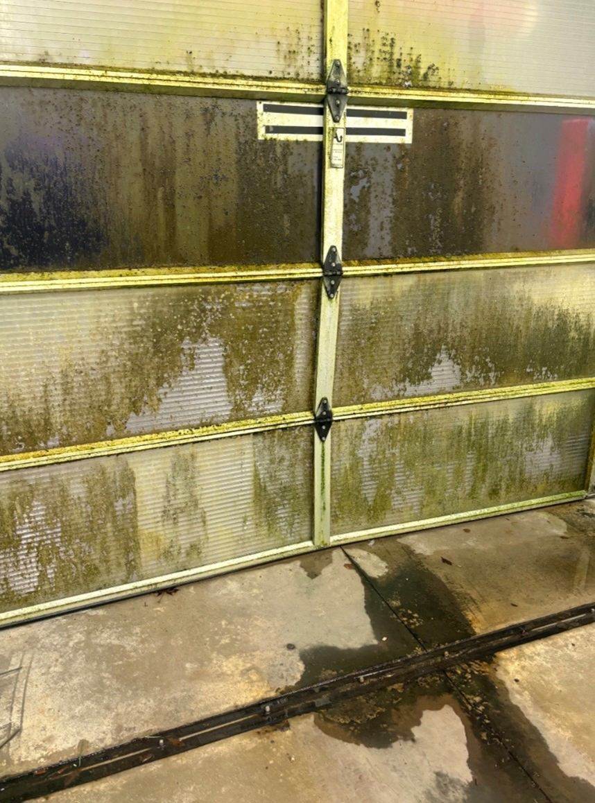Before: Car wash bay door steam cleaned