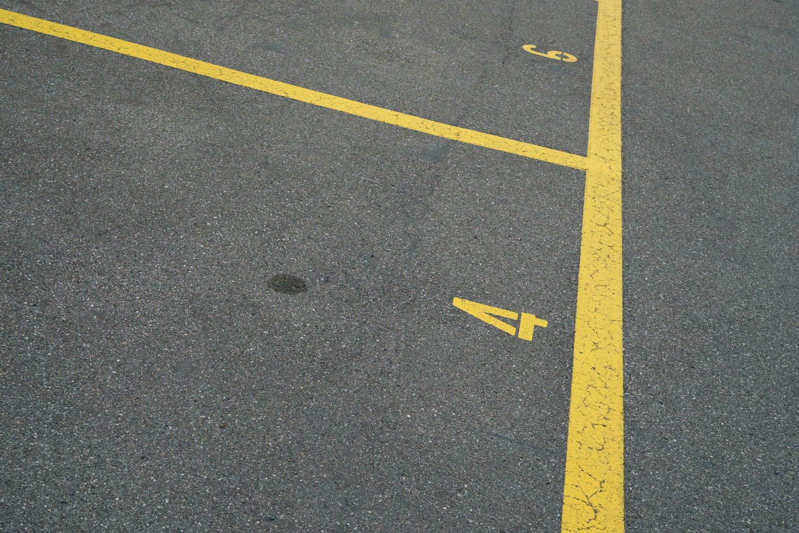 Our technician painting a fire lane curb in a commercial parking lot
